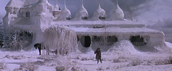 Movie still from “Doctor Zhivago” (1965), directed by David Lean – A person walking in the snow in front of a building covered in ice; Extreme Wide shot, High angle