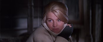Movie still from “Doctor Zhivago” (1965), directed by David Lean – A woman in a white sweater is looking at the camera; Close Up shot, Low angle