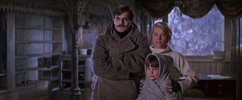 Movie still from “Doctor Zhivago” (1965), directed by David Lean – A man and a woman and a child standing in a room; Medium shot, Low angle
