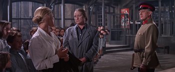 Movie still from “Doctor Zhivago” (1965), directed by David Lean – A woman standing in front of a group of people; Medium shot, Over the shoulder angle