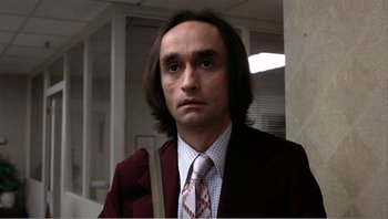 Movie still from “Dog Day Afternoon” (1975), directed by Sidney Lumet – A man in a suit and tie in a room; Close Up shot, Low angle