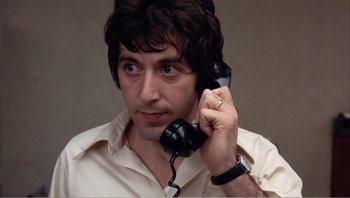 Movie still from “Dog Day Afternoon” (1975), directed by Sidney Lumet – A man holding a phone up to his ear; Close Up shot, Low angle