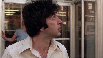 Movie still from “Dog Day Afternoon” (1975), directed by Sidney Lumet – A person wearing a white shirt looking to the side; Close Up shot, Low angle
