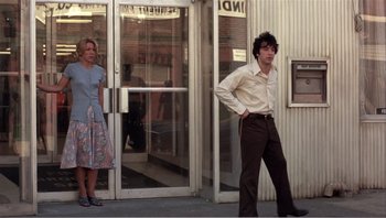 Movie still from “Dog Day Afternoon” (1975), directed by Sidney Lumet – A man and a woman standing in front of a building; Wide shot, Low angle