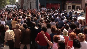 Movie still from “Dog Day Afternoon” (1975), directed by Sidney Lumet – A large group of people standing in a crowd; Wide shot, High angle