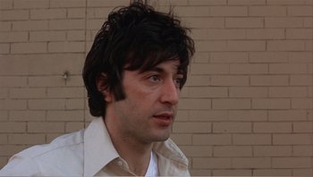 Movie still from “Dog Day Afternoon” (1975), directed by Sidney Lumet – A person wearing a white shirt; Close Up shot, Low angle