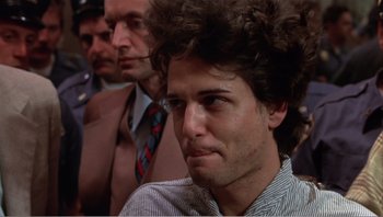 Movie still from “Dog Day Afternoon” (1975), directed by Sidney Lumet – A person wearing a suit and tie; Close Up shot, Low angle