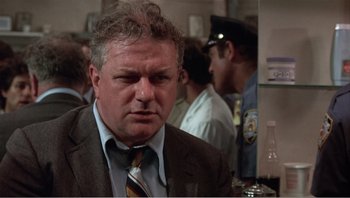 Movie still from “Dog Day Afternoon” (1975), directed by Sidney Lumet – A person wearing a suit and tie; Close Up shot, Low angle