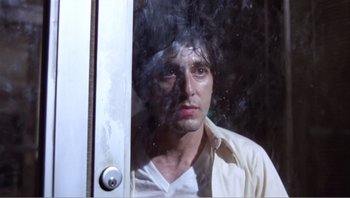 Movie still from “Dog Day Afternoon” (1975), directed by Sidney Lumet – A man standing in front of a window looking sad; Close Up shot, Low angle