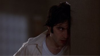 Movie still from “Dog Day Afternoon” (1975), directed by Sidney Lumet – A young man hiding his face behind a wall; Close Up shot, Low angle