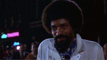 Movie still from “Dog Day Afternoon” (1975), directed by Sidney Lumet – A man with a beard is smiling for the camera; Close Up shot, Low angle