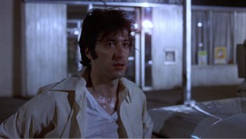 Movie still from “Dog Day Afternoon” (1975), directed by Sidney Lumet – A man in a white shirt is looking to his left; Close Up shot, Low angle