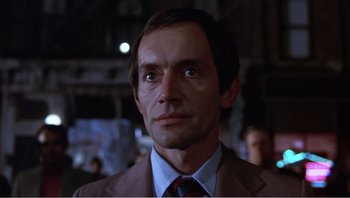 Movie still from “Dog Day Afternoon” (1975), directed by Sidney Lumet – A person wearing a suit and tie; Close Up shot, Low angle