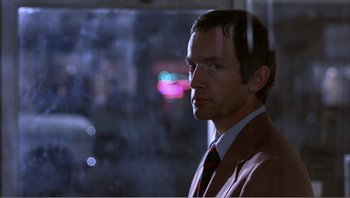 Movie still from “Dog Day Afternoon” (1975), directed by Sidney Lumet – A person wearing a suit and tie; Close Up shot, Over the shoulder angle