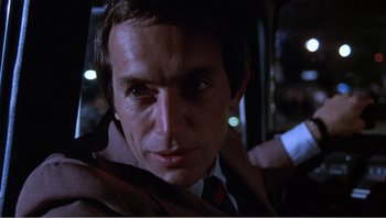 Movie still from “Dog Day Afternoon” (1975), directed by Sidney Lumet – A person wearing a suit and tie; Close Up shot, Low angle