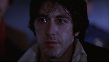Movie still from “Dog Day Afternoon” (1975), directed by Sidney Lumet – A man's face in a dark room; Close Up shot, Low angle