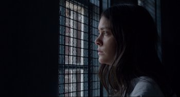Movie still from “The New Mutants” (2020), directed by Josh Boone – A woman looking out of a jail cell window; Close Up shot, Low angle