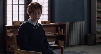 Movie still from “The New Mutants” (2020), directed by Josh Boone – A young man sitting in a chair in a room; Medium shot, High angle