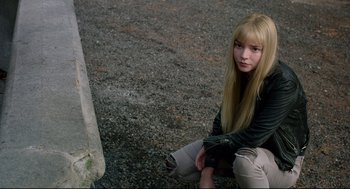 Movie still from “The New Mutants” (2020), directed by Josh Boone – A young woman sitting on the side of the road; Medium shot, High angle