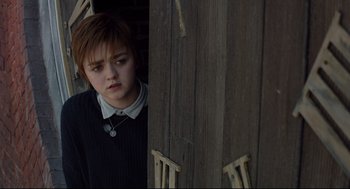 Movie still from “The New Mutants” (2020), directed by Josh Boone – A young girl standing in front of a wooden door; Close Up shot, High angle