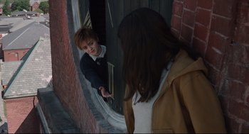 Movie still from “The New Mutants” (2020), directed by Josh Boone – A woman looking in the mirror of a door way; Medium shot, Over the shoulder angle