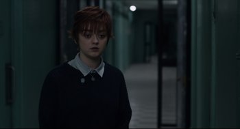 Movie still from “The New Mutants” (2020), directed by Josh Boone – A woman with red hair standing in a dark hallway; Medium shot, Over the shoulder angle