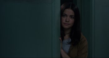 Movie still from “The New Mutants” (2020), directed by Josh Boone – A young woman standing behind a green door looking at the camera; Close Up shot, Over the shoulder angle
