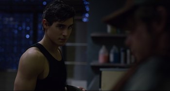 Movie still from “The New Mutants” (2020), directed by Josh Boone – A man in a black tank top looking at the camera; Close Up shot, Over the shoulder angle