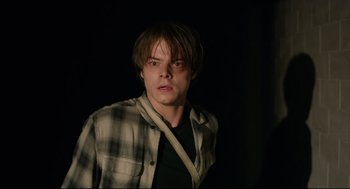 Movie still from “The New Mutants” (2020), directed by Josh Boone – A young man in a black shirt and a plaid shirt; Close Up shot, Over the shoulder angle