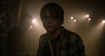 Movie still from “The New Mutants” (2020), directed by Josh Boone – A young man in a dark room with lights in the background; Close Up shot, Over the shoulder angle
