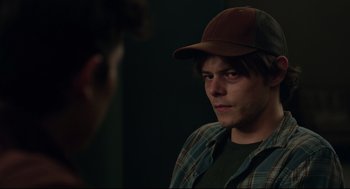 Movie still from “The New Mutants” (2020), directed by Josh Boone – A young man wearing a hat looking into a mirror; Close Up shot, Over the shoulder angle