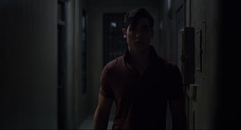 Movie still from “The New Mutants” (2020), directed by Josh Boone – A young man standing in a dark hallway; Close Up shot, Over the shoulder angle