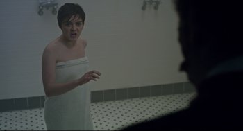 Movie still from “The New Mutants” (2020), directed by Josh Boone – A woman in a towel in front of a bathroom mirror; Medium shot, Over the shoulder angle
