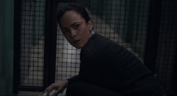 Movie still from “The New Mutants” (2020), directed by Josh Boone – A woman sitting in front of a metal fence; Close Up shot, Over the shoulder angle