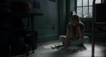 Movie still from “The New Mutants” (2020), directed by Josh Boone – A girl sitting on the floor drawing with crayons; Wide shot, High angle