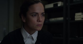 Movie still from “The New Mutants” (2020), directed by Josh Boone – A woman wearing a suit and white shirt looking into the distance; Close Up shot, Over the shoulder angle