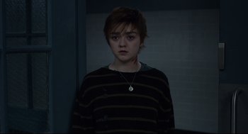 Movie still from “The New Mutants” (2020), directed by Josh Boone – A young woman in a striped shirt is looking at the camera; Medium shot, High angle