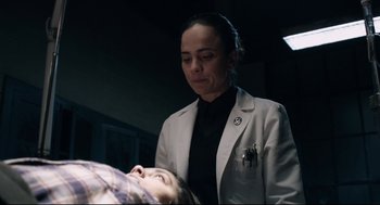 Movie still from “The New Mutants” (2020), directed by Josh Boone – A woman standing next to a woman lying on a bed; Medium shot, Over the shoulder angle