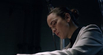 Movie still from “The New Mutants” (2020), directed by Josh Boone – A woman sitting in front of a microphone in a dark room; Close Up shot, Low angle