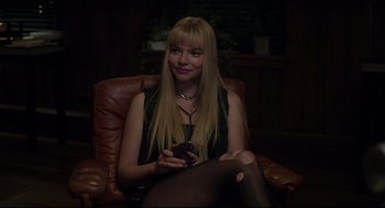 Movie still from “The New Mutants” (2020), directed by Josh Boone – A woman sitting in a chair holding a cell phone; Medium shot, Over the shoulder angle