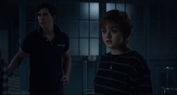 Movie still from “The New Mutants” (2020), directed by Josh Boone – A young woman standing next to a young man in a room; Medium shot, Over the shoulder angle