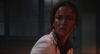 Movie still from “The New Mutants” (2020), directed by Josh Boone – A woman in a white lab coat with blood all over her face; Close Up shot, Low angle