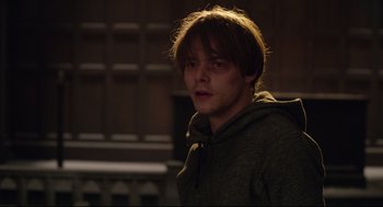 Movie still from “The New Mutants” (2020), directed by Josh Boone – A young man in a hooded sweatshirt looks at the camera; Close Up shot, Over the shoulder angle