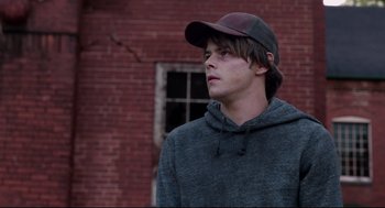 Movie still from “The New Mutants” (2020), directed by Josh Boone – A young man wearing a hat and a sweatshirt; Close Up shot, Over the shoulder angle