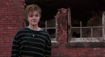 Movie still from “The New Mutants” (2020), directed by Josh Boone – A young man standing in front of a brick building; Close Up shot, Over the shoulder angle