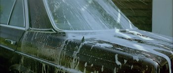 Movie still from “Dogtooth” (2009), directed by Yorgos Lanthimos – View of the side of a car; Extreme Close Up shot, Low angle