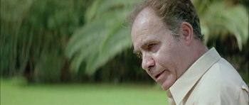 Movie still from “Dogtooth” (2009), directed by Yorgos Lanthimos – A person looking down at his face; Close Up shot, Low angle