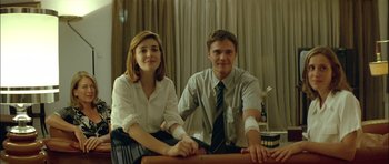 Movie still from “Dogtooth” (2009), directed by Yorgos Lanthimos – A man and a woman sitting next to each other; Medium shot, Low angle