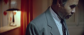 Movie still from “Dogtooth” (2009), directed by Yorgos Lanthimos – A person wearing a suit; Close Up shot, Low angle