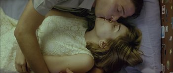 Movie still from “Dogtooth” (2009), directed by Yorgos Lanthimos – A man and a woman kissing on a bed; Close Up shot, Low angle